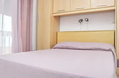 a bedroom with a bed and a dresser at Apartamento Andujar in Cádiz