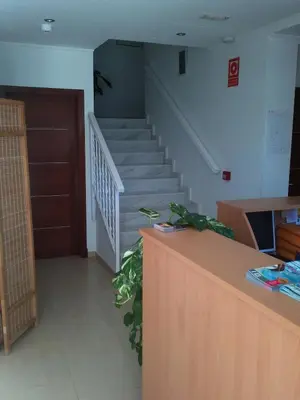 a staircase in a room with a stair case at Hostal Victoria Mar in Chipiona
