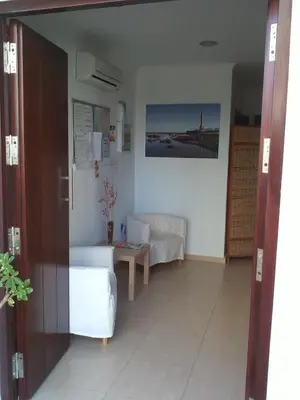 a living room with a couch and a table at Hostal Victoria Mar in Chipiona
