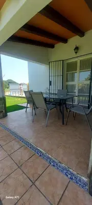 a patio with a table and chairs on it at Chalet la Huerta con piscina y wifi in Conil de la Frontera