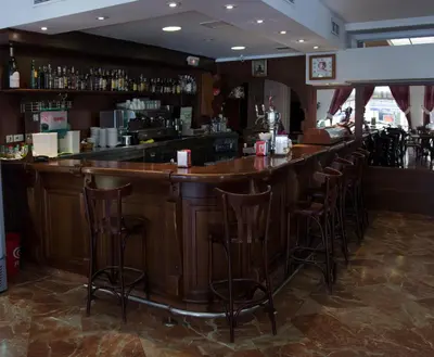 a bar with wooden bar stools in a restaurant at Hotel Peña de Arcos in Arcos de la Frontera