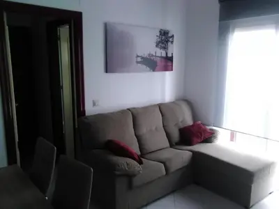 a living room with a couch and a window at Piso en centro histórico in Jerez de la Frontera
