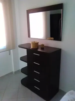 a bathroom with a black dresser and a mirror at Piso en centro histórico in Jerez de la Frontera