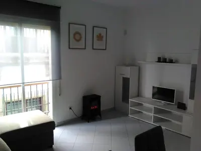 a living room with a couch and a television at Piso en centro histórico in Jerez de la Frontera