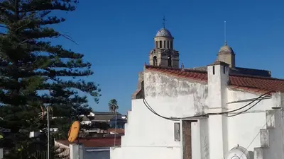 a white building with a clock tower on top of it at Piso en centro histórico in Jerez de la Frontera