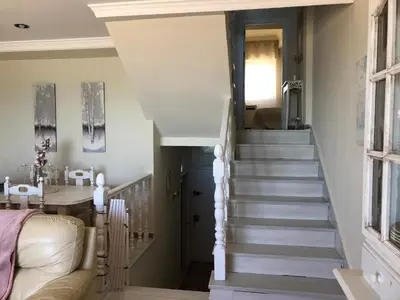 a staircase in a living room with a couch at Luxury Oceanfront triplex in Cadiz in Cádiz