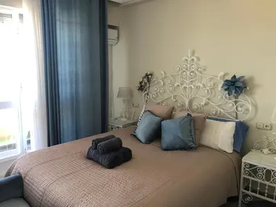 a bedroom with a large bed with a large headboard at Luxury Oceanfront triplex in Cadiz in Cádiz