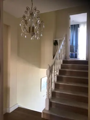 a staircase with a chandelier in a house at Luxury Oceanfront triplex in Cadiz in Cádiz