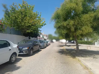 a row of cars parked on the side of a street at Moderno Apartamento junto a la Playa in Sanlúcar de Barrameda
