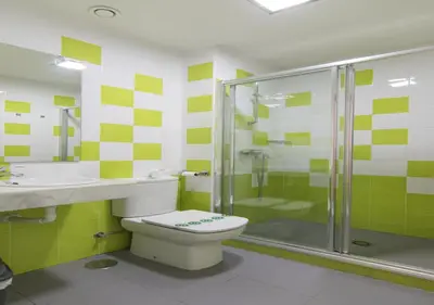 a bathroom with a toilet and a shower and a sink at Albergue Inturjoven Chipiona in Chipiona