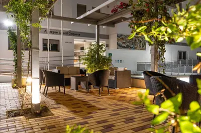 a restaurant with chairs and tables in a building at Albergue Inturjoven Chipiona in Chipiona