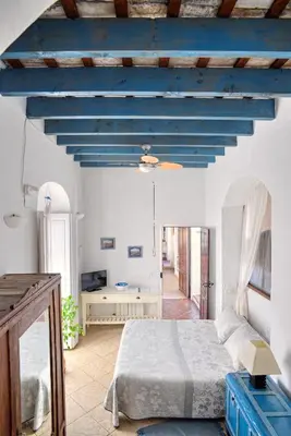 a bedroom with a bed and a blue ceiling at La Casa de Bovedas Charming Inn in Arcos de la Frontera
