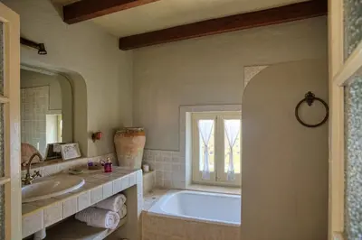 a bathroom with a tub and a sink and a window at La Casa de Bovedas Charming Inn in Arcos de la Frontera