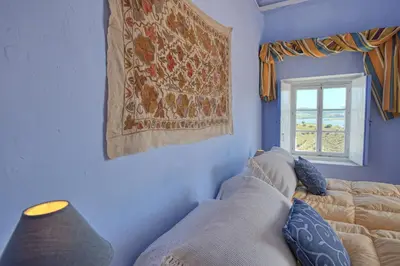 a living room with a couch and a window at La Casa de Bovedas Charming Inn in Arcos de la Frontera