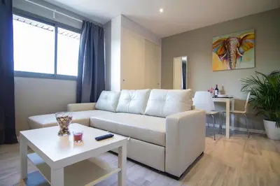 a living room with a white couch and a table at estudio santa maria in El Puerto de Santa María