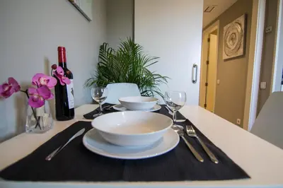 a table with a bowl and plates and wine glasses at estudio santa maria in El Puerto de Santa María