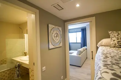 a bedroom with a bed and a bathroom with a tub at estudio santa maria in El Puerto de Santa María