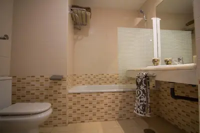 a bathroom with a toilet and a sink and a tub at estudio santa maria in El Puerto de Santa María