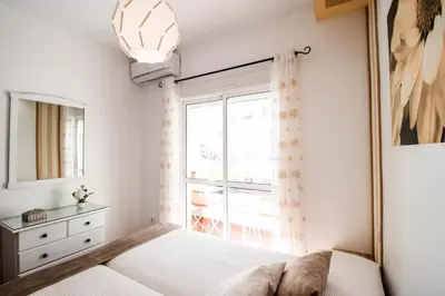 a bedroom with a bed and a window at Summerland Apartments Rota in Rota