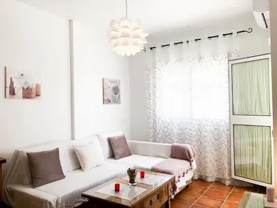 a living room with a white couch and a table at Summerland Apartments Rota in Rota