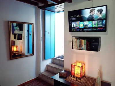 a room with a mirror and a tv on the wall at Casa Campana in Arcos de la Frontera