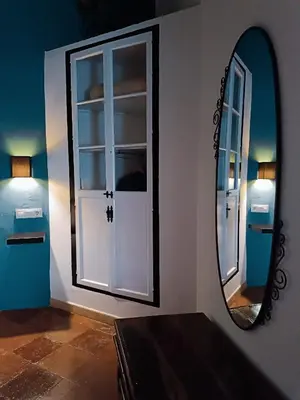 a mirror on a wall next to a door at Casa Campana in Arcos de la Frontera