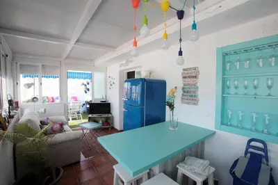 a living room with a blue table and a blue refrigerator at Ático con Encanto in Sanlúcar de Barrameda