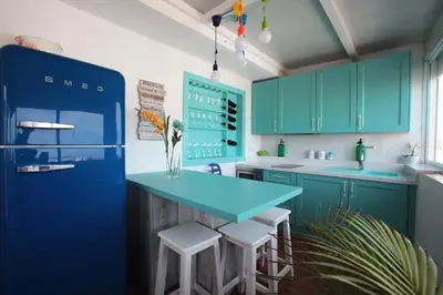 a kitchen with blue cabinets and a blue counter top at Ático con Encanto in Sanlúcar de Barrameda