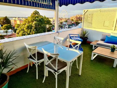 a table and chairs on a balcony with a view at Ático con Encanto in Sanlúcar de Barrameda