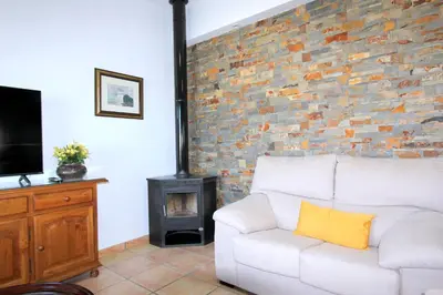 a living room with a white couch and a fireplace at Villa Rocío-Conil in Conil de la Frontera