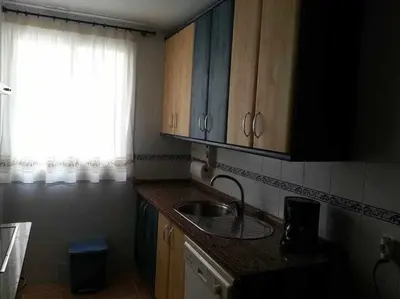 a small kitchen with a sink and a window at Enjoy Life Chipiona in Chipiona
