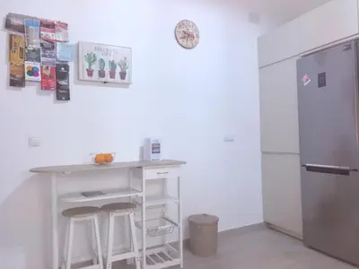 a kitchen with a counter and a refrigerator at La Caleta de Cadiz WiFi in Cádiz