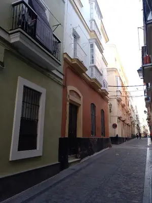 an empty street in a city with buildings at La Caleta de Cadiz WiFi in Cádiz