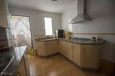 a kitchen with a sink and a counter top at Ático Las Infantas- Parking gratuito in Sanlúcar de Barrameda