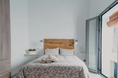a bedroom with a large bed with two slippers at Casa Palacio -Sanlúcar- in Sanlúcar de Barrameda