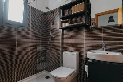 a bathroom with a toilet and a sink at Casa Palacio -Sanlúcar- in Sanlúcar de Barrameda
