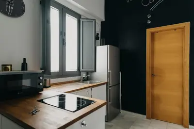 a kitchen with a sink and a refrigerator at Casa Palacio -Sanlúcar- in Sanlúcar de Barrameda