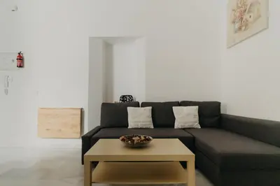 a living room with a couch and a coffee table at Casa Palacio -Sanlúcar- in Sanlúcar de Barrameda