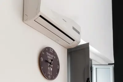a clock hanging on a wall in a room at Casa Palacio -Sanlúcar- in Sanlúcar de Barrameda
