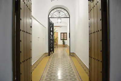 an empty hallway with an archway and a hallway with wooden doors at Casa Rural Pueblos Blancos in Bornos