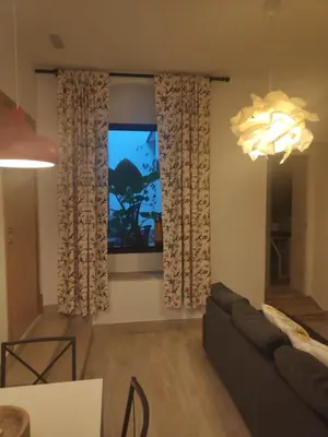 a living room with a couch and a large window at Casa Rural Pueblos Blancos in Bornos