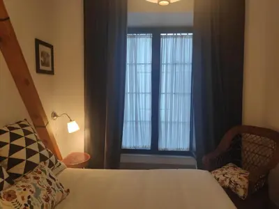 a bedroom with a bed and a window and a chair at Casa Rural Pueblos Blancos in Bornos