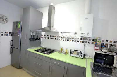 a kitchen with a stove and a refrigerator at Apartamento Duque de Arcos 2 in Arcos de la Frontera