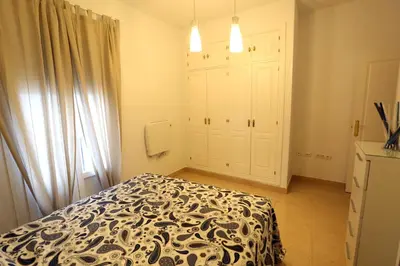 a bedroom with a bed with a black and white blanket at Apartamento Duque de Arcos 2 in Arcos de la Frontera
