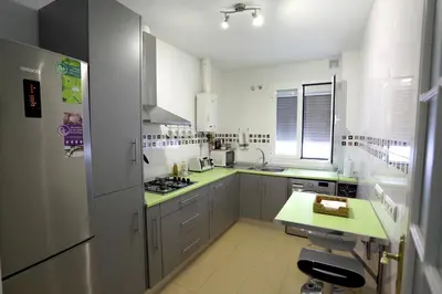 a kitchen with white cabinets and green counter tops at Apartamento Duque de Arcos 2 in Arcos de la Frontera