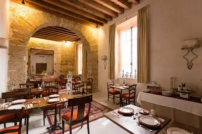 a restaurant with tables and chairs in a room at Hotel Casa de las Cuatro Torres in Cádiz