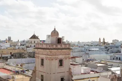 a view of a city with a clock tower at Hotel Casa de las Cuatro Torres in Cádiz