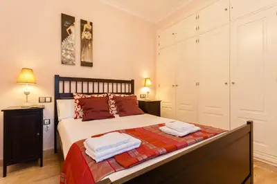a bedroom with a bed with two towels on it at El Atico de los INGLESES by Cadiz4Rentals in Cádiz