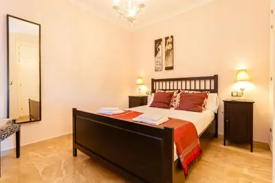 a bedroom with a large bed and a mirror at El Atico de los INGLESES by Cadiz4Rentals in Cádiz