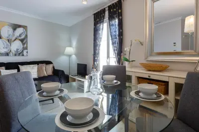 a living room with a glass table and chairs at El Atico de los INGLESES by Cadiz4Rentals in Cádiz